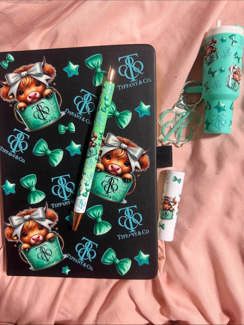 Black journal with matching pen, mini Stanley cup keychain & chapstick.